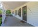 Inviting front porch featuring a covered area, rustic shutters, and a decorative welcome mat at 2334 Highway 278, Social Circle, GA 30025