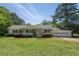 Charming single-story home featuring a welcoming front porch and well-maintained landscaping on a sunny day at 2334 Highway 278, Social Circle, GA 30025