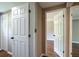 View of a hallway with multiple doors with wood-look floors at 2334 Highway 278, Social Circle, GA 30025