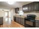 Galley-style kitchen featuring granite countertops and stainless steel appliances at 2334 Highway 278, Social Circle, GA 30025