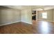 Spacious living room flowing into the kitchen, featuring hardwood floors and neutral wall colors at 2334 Highway 278, Social Circle, GA 30025