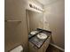 Neutral toned bathroom featuring a sink and vanity with framed mirror and lighting at 6531 Gina Agha Cir, Lithonia, GA 30038