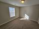 Bright bedroom features neutral walls, plush carpeting, and a window letting in natural light at 6531 Gina Agha Cir, Lithonia, GA 30038