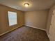 Bedroom with neutral walls and carpet, and a window at 6531 Gina Agha Cir, Lithonia, GA 30038