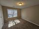 Bedroom with neutral walls, carpet, and a window at 6531 Gina Agha Cir, Lithonia, GA 30038