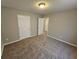 Bedroom with neutral walls and carpet and two entry doors at 6531 Gina Agha Cir, Lithonia, GA 30038