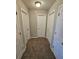 Hallway featuring multiple doors and neutral carpet at 6531 Gina Agha Cir, Lithonia, GA 30038