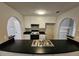 Well lit kitchen with black countertops, white cabinets, and stainless steel double basin sink at 6531 Gina Agha Cir, Lithonia, GA 30038