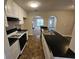 Well lit kitchen featuring black countertops, and white cabinets at 6531 Gina Agha Cir, Lithonia, GA 30038