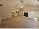 Cozy living room featuring a fireplace, neutral walls, and a ceiling fan at 6531 Gina Agha Cir, Lithonia, GA 30038