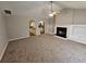 Bright living room with fireplace, ceiling fan, and convenient kitchen access at 6531 Gina Agha Cir, Lithonia, GA 30038