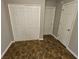 This room is equipped with wood-look tile flooring, a closet and two other white doors at 6531 Gina Agha Cir, Lithonia, GA 30038