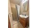 Small bathroom with shower and wood vanity at 831 Sinyard Rd, Lithia Springs, GA 30122