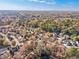 Aerial view of neighborhood with autumn foliage and distant city skyline at 589 Lantern Wood Dr, Scottdale, GA 30079