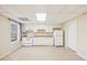 Basement kitchenette with white cabinets and appliances at 589 Lantern Wood Dr, Scottdale, GA 30079