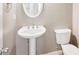 Clean bathroom with pedestal sink and toilet at 589 Lantern Wood Dr, Scottdale, GA 30079