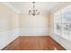 Bright dining room with hardwood floors, chandelier, and wainscoting at 589 Lantern Wood Dr, Scottdale, GA 30079