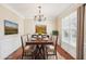 Formal dining room with hardwood floors and chandelier at 589 Lantern Wood Dr, Scottdale, GA 30079