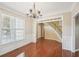 Formal dining room with hardwood floors, chandelier, and views to entry at 589 Lantern Wood Dr, Scottdale, GA 30079