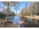 Wooden dock extending into a private lake at 589 Lantern Wood Dr, Scottdale, GA 30079