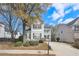 Two-story gray house with a two-car garage and a landscaped yard at 589 Lantern Wood Dr, Scottdale, GA 30079