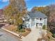 Two-story house with gray siding, a two-car garage, and a landscaped yard at 589 Lantern Wood Dr, Scottdale, GA 30079