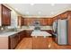 Well-equipped kitchen with stainless steel appliances and wood cabinets at 589 Lantern Wood Dr, Scottdale, GA 30079