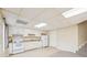 Basement kitchenette, featuring white appliances and cabinets at 589 Lantern Wood Dr, Scottdale, GA 30079