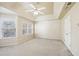 Main bedroom with bay windows and ceiling fan at 589 Lantern Wood Dr, Scottdale, GA 30079