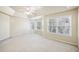 Main bedroom with bay windows and ceiling fan at 589 Lantern Wood Dr, Scottdale, GA 30079