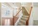 Elegant staircase with wooden railing and carpeted steps at 589 Lantern Wood Dr, Scottdale, GA 30079