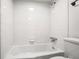 Clean bathroom with white tiled walls and a bathtub at 1150 Collier Nw Rd # K9, Atlanta, GA 30318