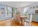 Formal dining room with a large table, chandelier, and hardwood floors at 527 Main St, Suwanee, GA 30024