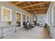 Relaxing screened porch with seating area and ceiling fan at 527 Main St, Suwanee, GA 30024