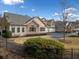 Tan siding and stone exterior, two car garage, and manicured lawn at 224 Orchards Cir, Woodstock, GA 30188