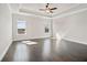 Primary bedroom features windows and hardwood floors at 627 Skytop Dr, Cumming, GA 30040