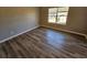 Empty bedroom with hardwood floors and a window at 145 W Village W Ct, Riverdale, GA 30296