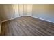 Spacious bedroom with wood-look floors and neutral walls at 145 W Village W Ct, Riverdale, GA 30296