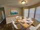 Bright dining room with a table set for six and large windows at 145 W Village W Ct, Riverdale, GA 30296