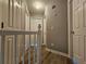 Upstairs hallway with hardwood floors and multiple doors at 145 W Village W Ct, Riverdale, GA 30296