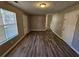 Open living room with hardwood floors and two entrances at 145 W Village W Ct, Riverdale, GA 30296