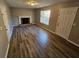 Living room with fireplace and hardwood floors at 145 W Village W Ct, Riverdale, GA 30296
