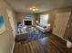 Living room with fireplace, comfortable seating, and hardwood floors at 145 W Village W Ct, Riverdale, GA 30296
