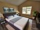 Main bedroom with king-size bed and large window at 145 W Village W Ct, Riverdale, GA 30296