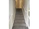 Indoor staircase with carpeted steps and white railings at 145 W Village W Ct, Riverdale, GA 30296