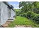 Landscaped backyard with a small patio area and surrounding greenery at 2436 Clarissa Nw Dr, Atlanta, GA 30318