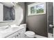 Updated bathroom featuring a modern vanity, toilet, mirror, and tiled shower, creating a refreshing space at 2436 Clarissa Nw Dr, Atlanta, GA 30318