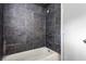 Bathroom featuring gray tiling along the walls and shower/tub combo at 2436 Clarissa Nw Dr, Atlanta, GA 30318