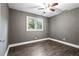 Inviting bedroom with wood-look floors, a ceiling fan, and a bright window offering pleasant natural light at 2436 Clarissa Nw Dr, Atlanta, GA 30318