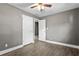 The bedroom features wood-look floors, a ceiling fan, and adjacent access to other rooms at 2436 Clarissa Nw Dr, Atlanta, GA 30318